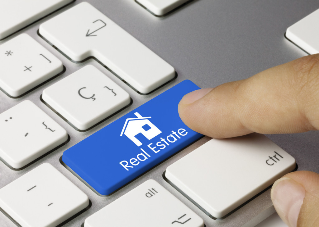 Real Estate keyboard key. Finger